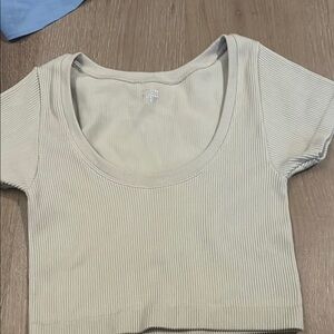 Cream colored and white cropped tight fitted shirts, $17 for each